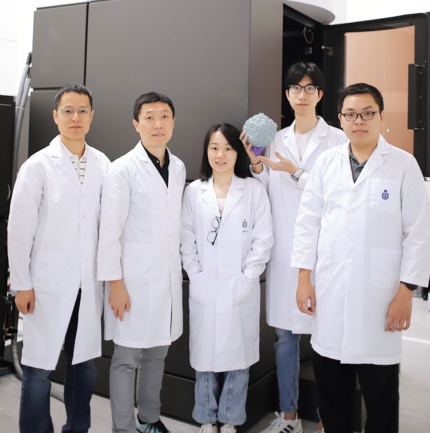 Photo of the research team, featuring Prof. DANG Shangyu, Prof. ZENG Qinglu, Dr. CAI Lanlan, Mr. LIU Hang (With the 3D printed cyanophage structure in his hands), and Mr. XIAO Shiwei, from left to right.