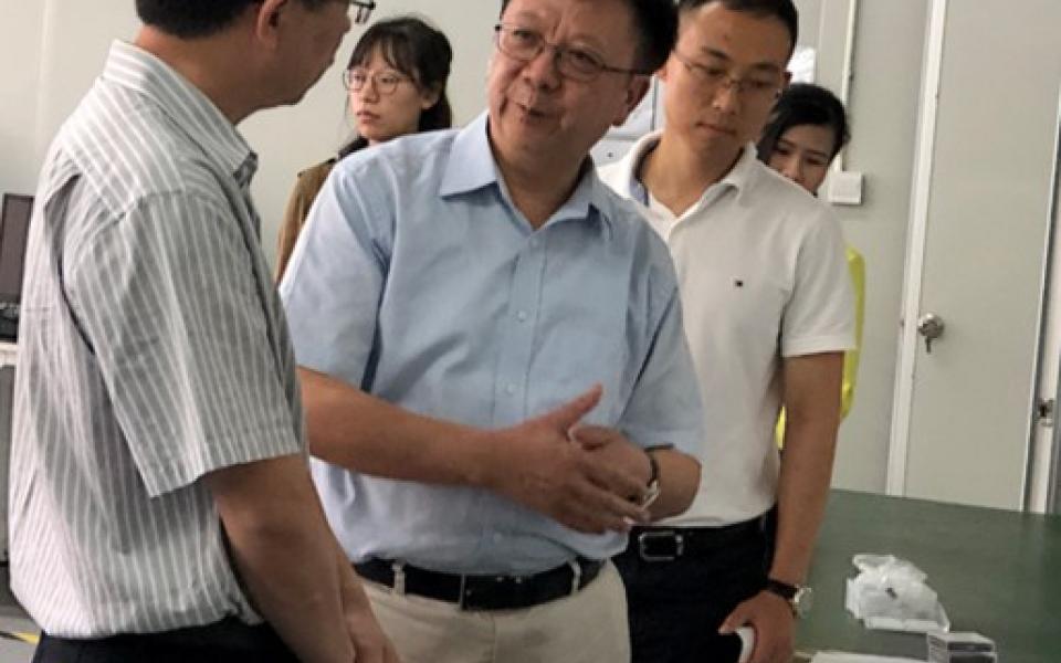 Prof. Wen (Middle) and Dr. Gao (right) introduce the theories behind their novel detection device in their research base at Shenzhen.