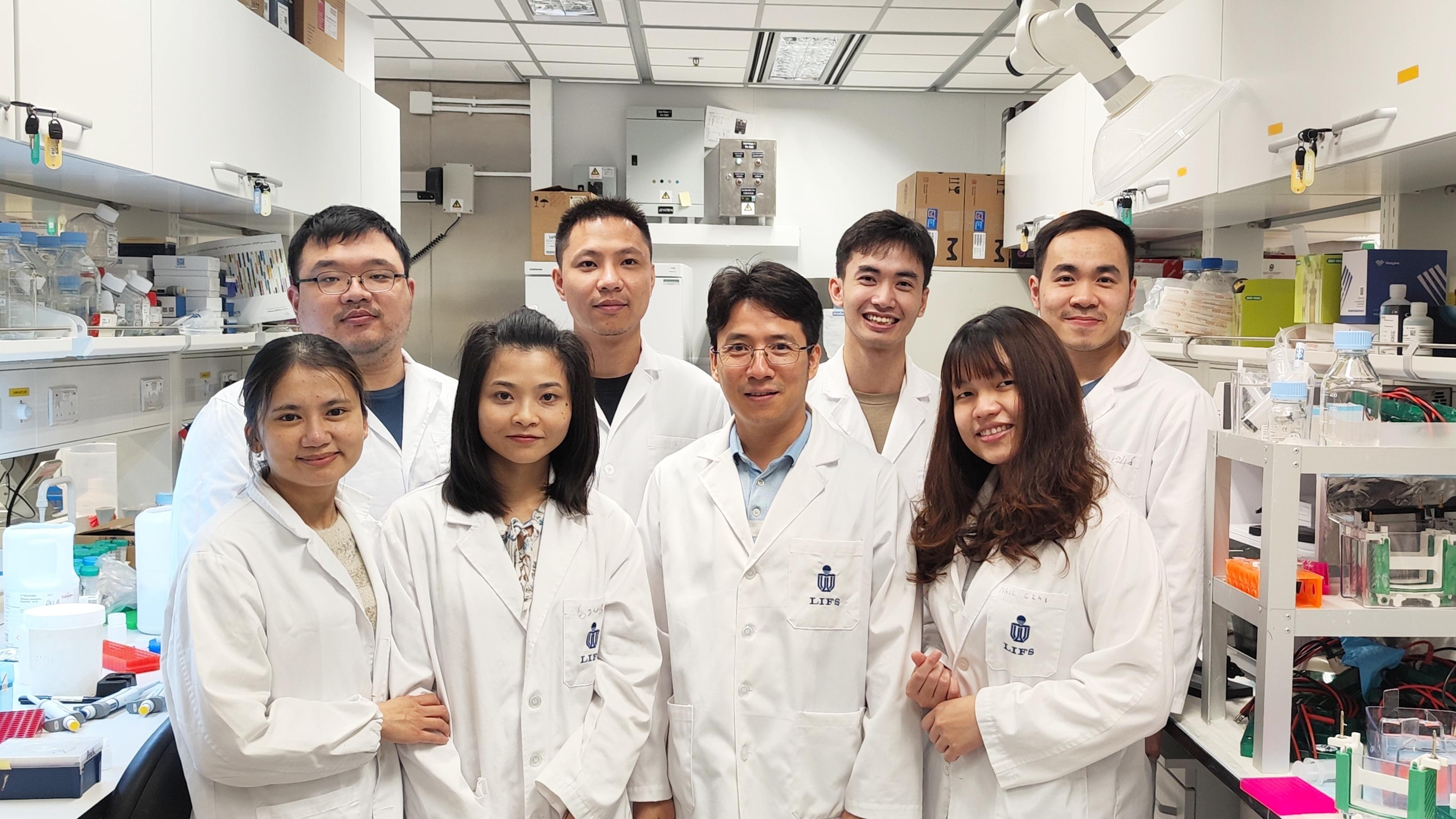 Prof. NGUYEN Tuan Anh (second right in the front row) and members of the RNA-Interacting Protein and Enzyme (RIPE) laboratory.
