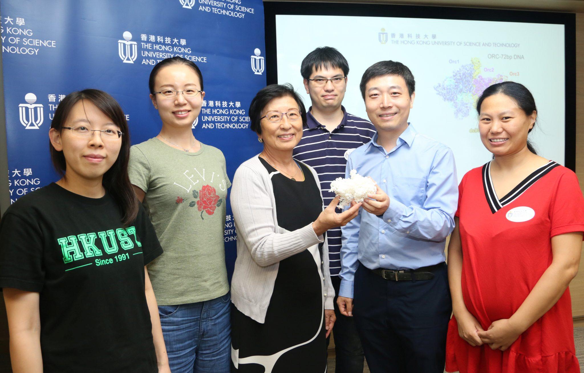 Prof Bik Tye (third left) and Prof Yuanliang Zhai (second right) holding an ORC model with members of the research team